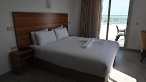 Postel nebo postele na pokoji v ubytování Hotel Centre Ville