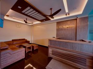 a salon with a waiting room with a barber shop at Lee Rooms in Nāgercoil