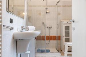 a bathroom with a sink and a shower at Casa Elisa in Luino +17 photos