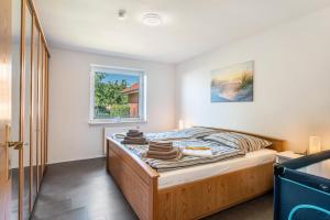 a bed in a room with a window at Ferienhaus Sonja in Waabs