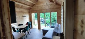 a living room with a couch and a table at Domek nad jeziorem Giżyno - cisza i natura Piotiwo D3 in Giżyno