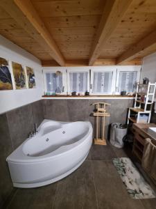 a large white bath tub in a room with a ceiling at LoSteLaDa sul lago di Como in Colico +45 photos
