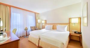 Postel nebo postele na pokoji v ubytování The Q - Quadro City Hotel