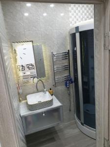 a bathroom with a sink and a large mirror at VIALPI Guest House in Gyumri +19 photos