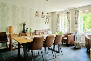 a living room with a wooden table and chairs at B&B Destiny in Maldegem