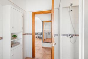 a bathroom with a shower and a mirror at Villa Vergara in Cala en Porter +11 photos