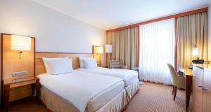 Postel nebo postele na pokoji v ubytování The Q - Quadro City Hotel