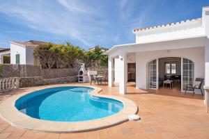 a swimming pool in front of a villa at Villa Vergara in Cala en Porter