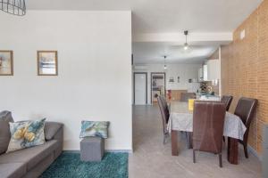 ein Wohn- und Esszimmer mit einer Couch und einem Tisch in der Unterkunft Casa Amarela in Ponte de Vagos