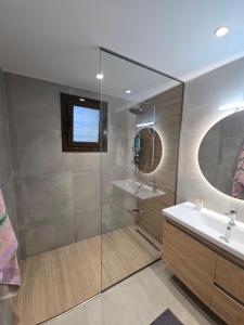 a bathroom with a shower with a sink and a mirror at Country House in Pastida +35 photos