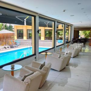 a hotel lobby with chairs and a swimming pool at Hotel 153 in Castelldefels +82 photos