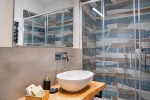 a bathroom with a sink and a glass shower at GuestHost - Casa Innocenza in Ravenna +38 photos