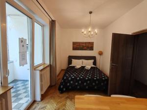 a bedroom with a bed and a chandelier at Central 3 Budget Accomodation in Bucharest