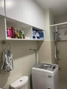 a small bathroom with a toilet and a sink at 2BR Condo SMDC Charm Metro Manila in Manila +7 photos