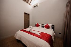 a bedroom with a bed with a stuffed animal on it at Urban Villas 5BR in Legian +4 photos
