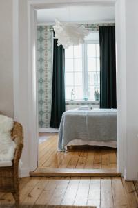 a bedroom with a bed and a large window at STF Gysinge Wärdshus & Hotell in Gysinge