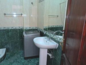 a bathroom with a sink and a trash can at Winter apartment in Luxor +86 photos