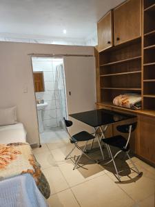 a room with a desk and a bed and a bedroom at WiseStar Guest House in Johannesburg