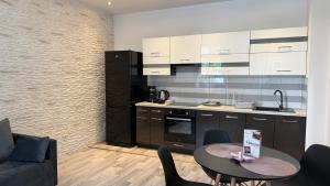 a kitchen with a table and some chairs and a counter at StayZdrój by LibertaRent in Wałbrzych