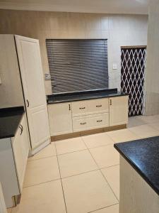 a large kitchen with a window and a counter top at WiseStar Guest House in Johannesburg