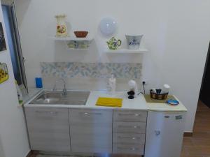 a kitchen with a sink and a counter top at Chiara BeachSuite in Palermo +91 photos