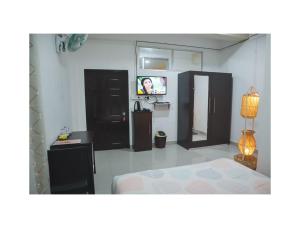 TV in/ali zabaviščno središče v nastanitvi Delight Inn