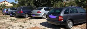 a row of parked cars parked in a parking lot at Aurora Glamping in Vama Veche +49 photos