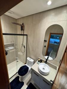 a bathroom with a toilet and a sink and a shower at Apartamento 424 Alter do Chão - Ilha Bela Residence in Santarém