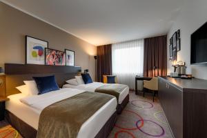 Giường trong phòng chung tại Leonardo Hotel Hannover Medical Park