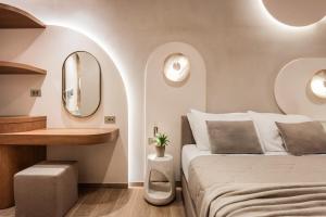 a bedroom with a bed and a mirror at Tzante Hotel Zakynthos, Adults Only in Laganas