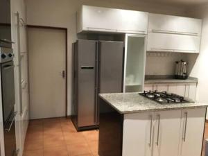 a kitchen with a refrigerator and a counter top at Mountain View Guest House in Underberg- House in Underberg