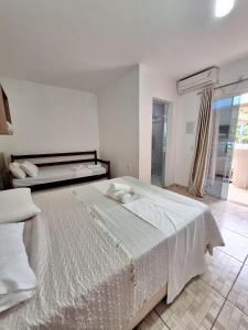 a bedroom with a large bed and a window at Coração Do Oceano Village in Penha +50 photos