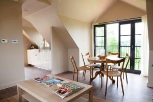 a kitchen and dining room with a table and chairs at The Lakehouse Apartment by inspirestays-com in Rudgwick