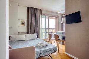 a bedroom with a bed and a living room at GiaxTower Gym Spa & Pool Bright Space in Milan