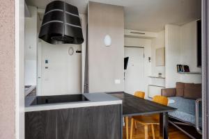 a kitchen with a sink and a counter top at GiaxTower Gym Spa & Pool Bright Space 6' piano in Milan