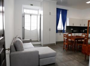 a living room with a couch and a table at Casa Senhor da Pedra in Vila Franca do Campo