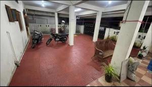 two motorcycles are parked in a large room at VL Vididhillu S-2 2BHK in Vizianagram City +8 photos