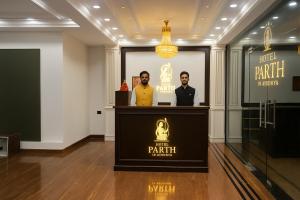 dois homens em pé no pódio de uma sala com uma apresentação em Hotel Parth Inn by IQ Hotels-Best Hotel Near Ram Mandir Ayodhya em Ayodhya