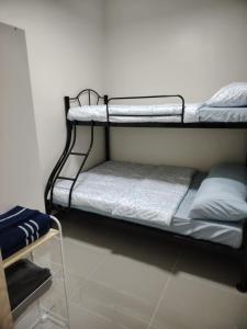 a couple of bunk beds in a room at 2BR Mountain View Condo SMDC Charm Metro Manila in Manila