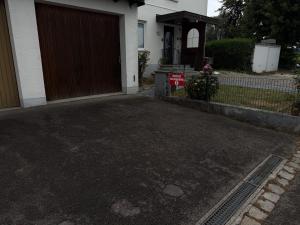 a driveway in front of a house with a garage at Rose in Günzburg
