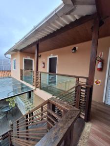 a balcony of a house with a glass floor at Coração Do Oceano Village in Penha