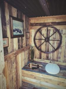 a bathroom with a sink and a large clock on the wall at Lodge romantique "esprit brocante" et son jacuzzi privatif in Lapalisse