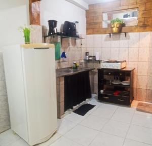 a kitchen with a sink and a refrigerator at Casa COP Maria bonita in Belém