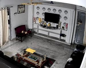 a living room with a couch and a tv at VL Vididhillu S-2 2BHK in Vizianagram City