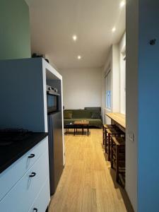 a kitchen and living room with a couch and a table at Appartamento Bianca in Prato