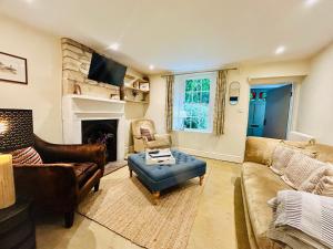 a living room with a couch and a fireplace at Quarry Cottage - Snug Hideaway in Box