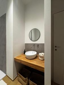a bathroom with a sink and a mirror on a counter at Appartamento Bianca in Prato