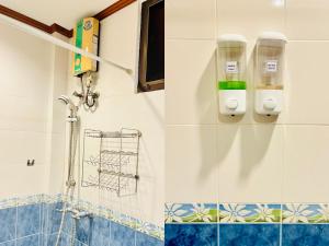 a bathroom with a shower and a soap dispenser on the wall at สวนไมตรีจิต รีสอร์ท in Ban Khlong Si +129 photos