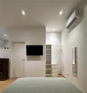 a living room with a flat screen tv on a wall at Appartamento Bianca in Prato