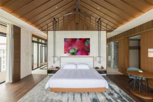 a bedroom with a large bed and a table at Hyatt Regency Seragaki Island Okinawa in Onna